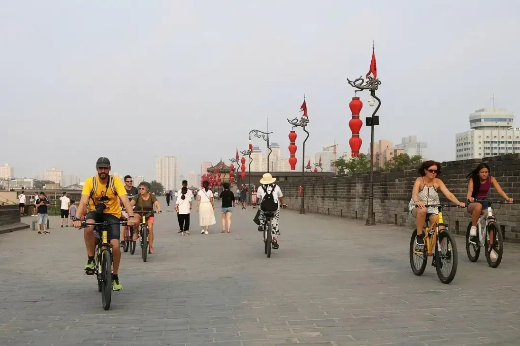 There are many people riding bikes on the Xi'an City Wall